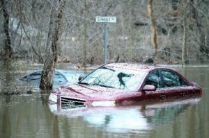 Car partially submerged in floodwaters