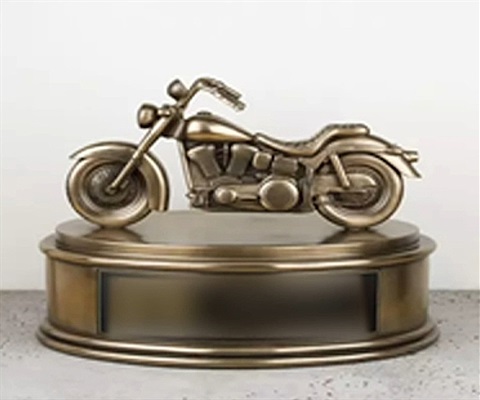 Urn for ashes with motorcycle on top