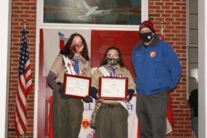 Eagle Scouts Kyra Lay and Kathryn Katie ˜' Sneddon of BSA Girl Troop 336 display certificates presented by Morris County Commissioner John Krickus.