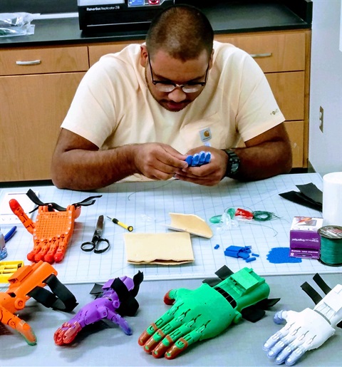 Student assembles a prosthetic hand